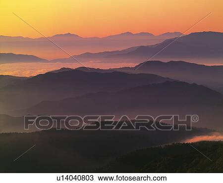 Stock Image - Sunrise over mountain range, Matsumoto, Nagano Prefecture, Japan. Fotosearch