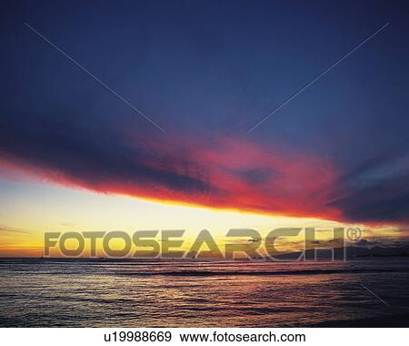 Stock Photo - Sunset over the ocean, Hawaii, USA. Fotosearch