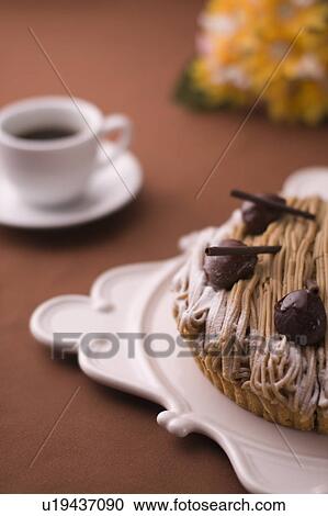 Tart with chestnut cream and a cup of coffee, colored background View Large Photo Image Stock Image - Tart with chestnut cream and a cup of coffee, colored background. Fotosearch