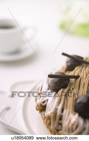 Stock Photo - Tart with chestnut cream and a cup of coffee, close up, white background. Fotosearch