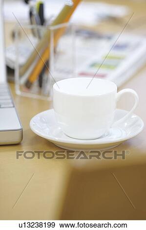 Tea cup on a desk View Large Photo Image Stock Photo - Tea cup on a desk. Fotosearch
