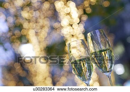 Two champagne flutes on a patio View Large Photo Image Picture - Two champagne flutes on a patio. Fotosearch