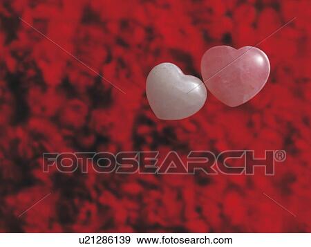 Stock Photo - Two hearts on red background. Fotosearch