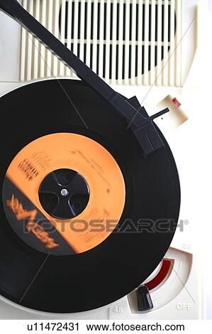 Stock Image - Vinyl record spinning on turntable. Fotosearch