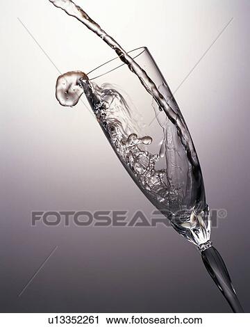 Water being poured into a champagne flute View Large Photo Image Stock Image - Water being poured into a champagne flute. Fotosearch