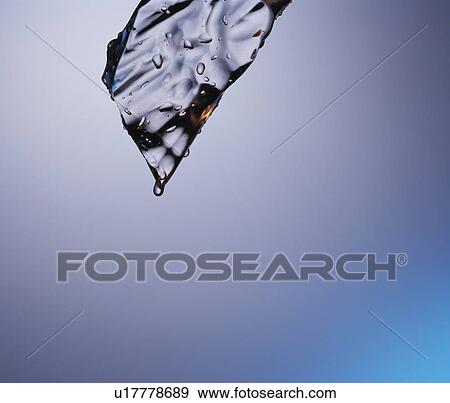Stock Photo - Water melting off an ice cube. Fotosearch