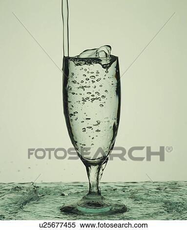 Water overflowing out of a cocktail glass View Large Photo Image Stock Photography - Water overflowing out of a cocktail glass. Fotosearch