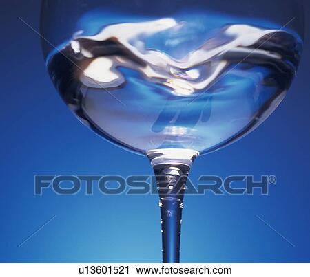 Stock Image - Water swirling in a wineglass. Fotosearch