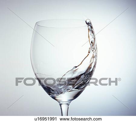 Stock Image - Water swishing in a wineglass. Fotosearch