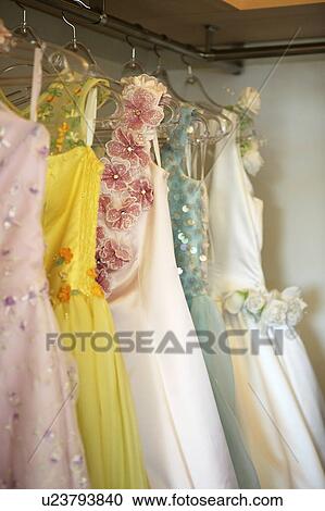Stock Image - Wedding dresses hanging in a store. Fotosearch