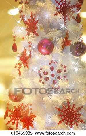 Stock Photography - White Christmas tree with red decorations. Fotosearch