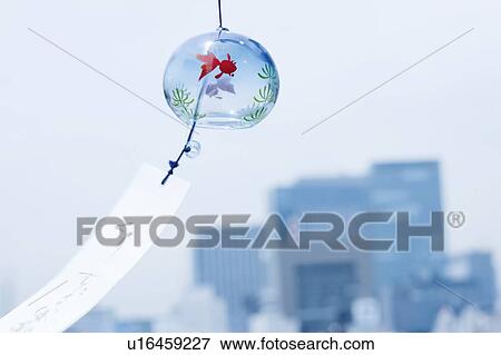 Wind Chime hanging in front of a cityscape View Large Photo Image Stock Photo - Wind Chime hanging in front of a cityscape. Fotosearch