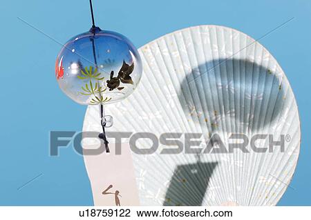 Stock Image - Windchime and fan. Fotosearch