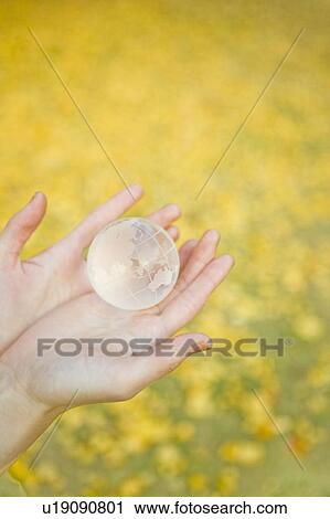 Woman holding glass globe in her hands View Large Photo Image Stock Image - Woman holding glass globe in her hands. Fotosearch