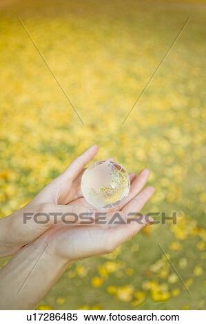 Stock Photography - Woman holding globe in hands. Fotosearch