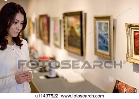Young woman in art gallery View Large Photo Image Stock Image - Young woman in art gallery. Fotosearch