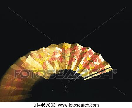Stock Image - Zoom effect on gold Japanese fan. Fotosearch