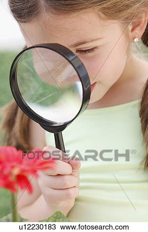 Child looking through magnifying glass View Large Photo Image Stock Image - Child looking through magnifying glass. Fotosearch
