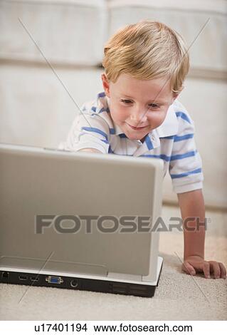 Picture - Child playing on computer. Fotosearch
