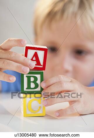 Stock Image - Child playing with ABC blocks. Fotosearch