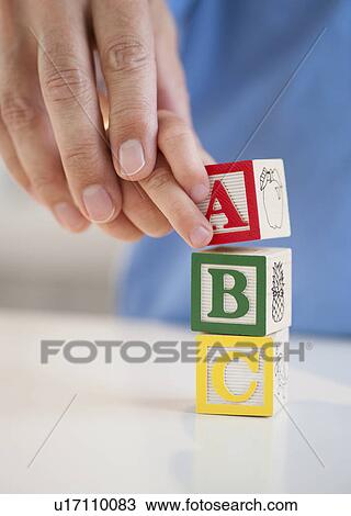 Stock Image - Child playing with ABC blocks. Fotosearch