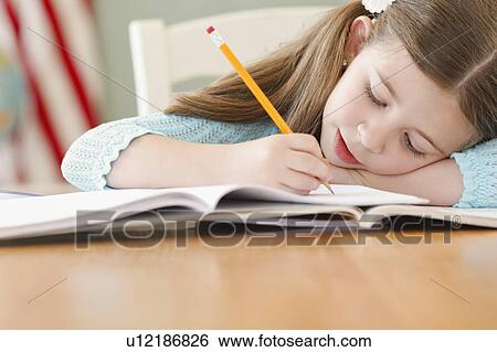Stock Photograph - Child studying. Fotosearch