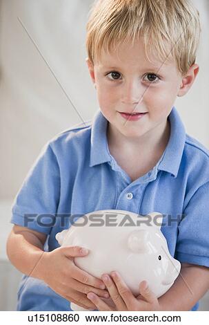 Stock Image - Child with piggybank. Fotosearch