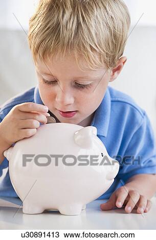 Stock Image - Child with piggybank. Fotosearch