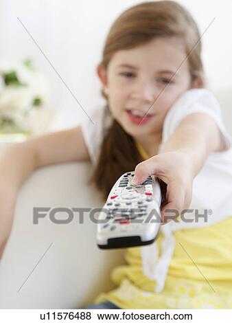 Stock Photo - Child with TV remote. Fotosearch