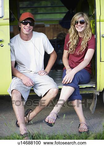 Stock Image - Couple in back of vehicle. Fotosearch