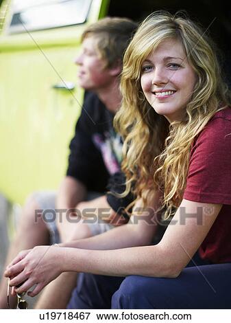 Stock Photo - Couple in back of vehicle. Fotosearch