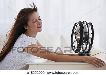 Fan blowing woman's face View Large Photo Image Stock Photo - Fan blowing woman's face. Fotosearch