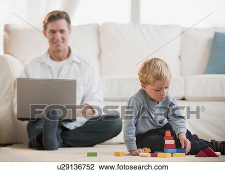 Father and child at home View Large Photo Image Stock Image - Father and child at home. Fotosearch