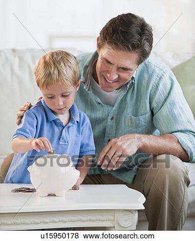 Father and child with piggybank View Large Photo Image Stock Photo - Father and child with piggybank. Fotosearch