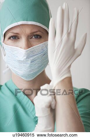 Female doctor putting on gloves View Large Photo Image Stock Photography - Female doctor putting on gloves. Fotosearch