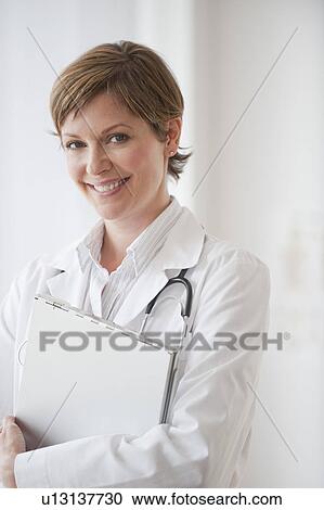 Female doctor smiling View Large Photo Image Stock Image - Female doctor smiling. Fotosearch