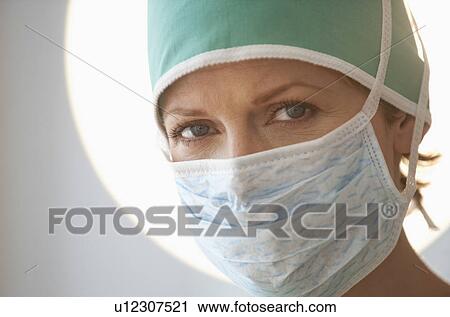 Stock Image - Female doctor with surgical mask. Fotosearch