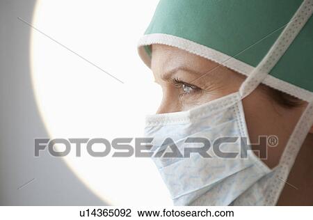 Stock Image - Female doctor with surgical mask. Fotosearch