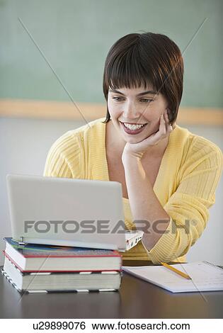 Stock Photograph - Female student on laptop. Fotosearch