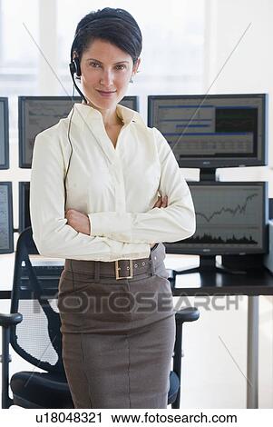 Stock Image - Female trader looking at camera. Fotosearch