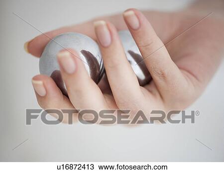 Stock Image - Hand holding Chinese balls. Fotosearch