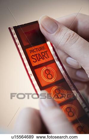 Stock Photo - hands holding film strip. Fotosearch