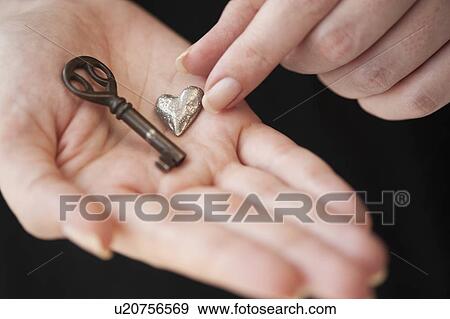 Stock Photo - Hands holding heart and key. Fotosearch