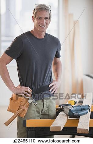 Stock Image - Male carpenter working. Fotosearch