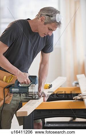 Stock Photograph - Male carpenter working. Fotosearch