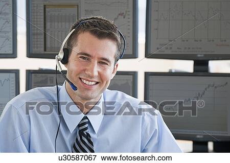 Stock Photo - Male trader with headset. Fotosearch