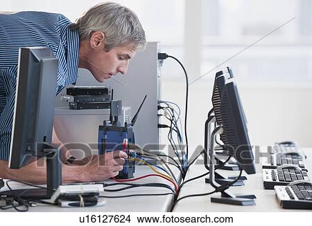 Man with networked computers View Large Photo Image Picture - Man with networked computers. Fotosearch
