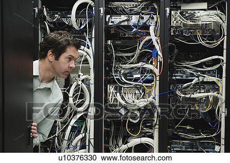 Man working in data center View Large Photo Image Stock Image - Man working in data center. Fotosearch