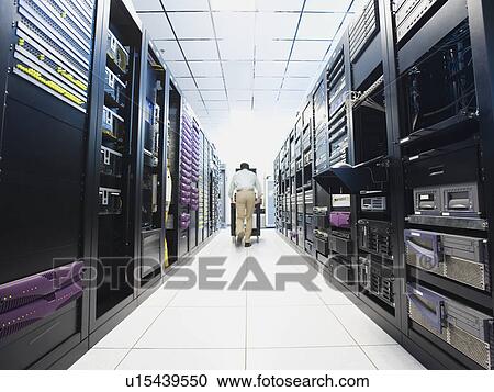 Stock Image - Man working in data center. Fotosearch