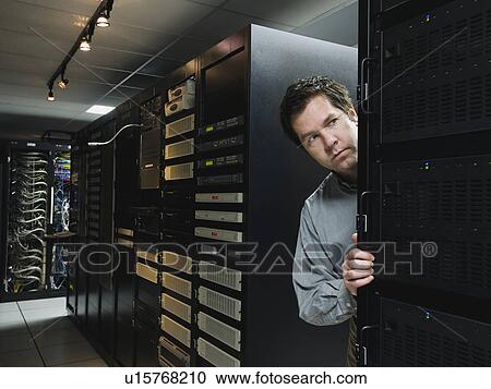Stock Image - Man working in data center. Fotosearch